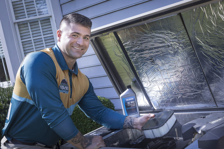 Electrician performing Kohler generator maintenance and filter replacement.