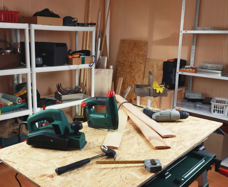 This image features a workshop scene with several woodworking power tools, notably the Bosch PHO series electric planers, such as the PHO 2000 or PHO 1500.