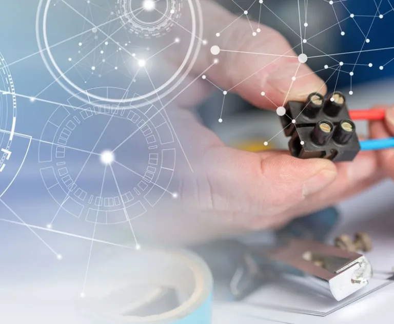 A close up of a hand holding a commercial electrical circuit.