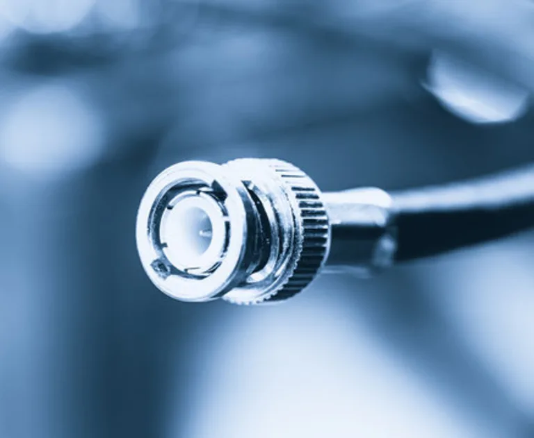 The item shown is a coaxial cable, specifically featuring a BNC connector commonly used for video applications.