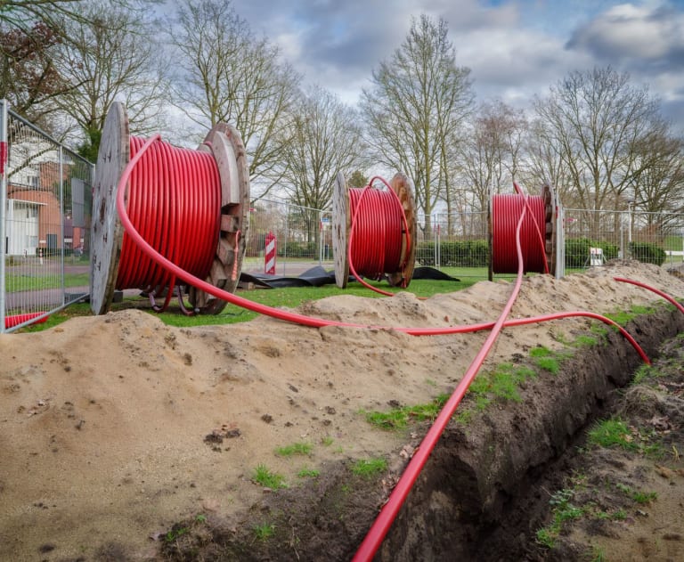 This image features fiber optic cables being installed underground.