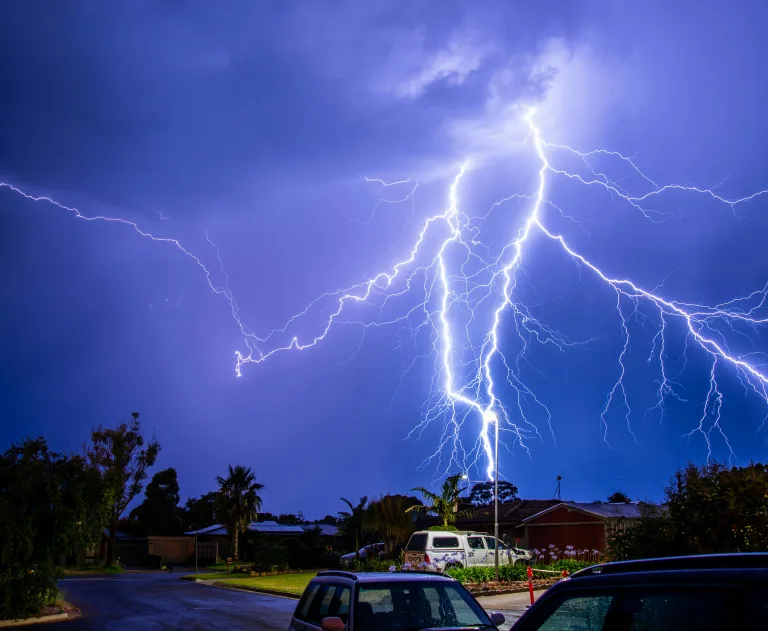 This image shows an intense cloud-to-ground lightning strike during a thunderstorm, an event that can cause a thunderstorm.