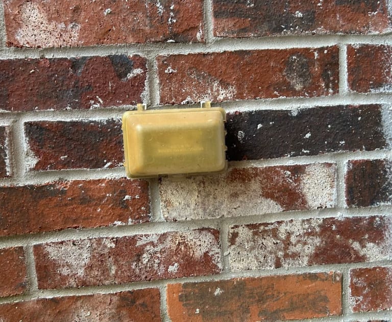 This item is a protective plastic cover for an outdoor electrical outlet, often referred to as a "bubble cover" or "in-use cover". It protects outdoor receptacles from rain, snow, and ice, allowing cords to remain plugged in safely while the cover is closed.