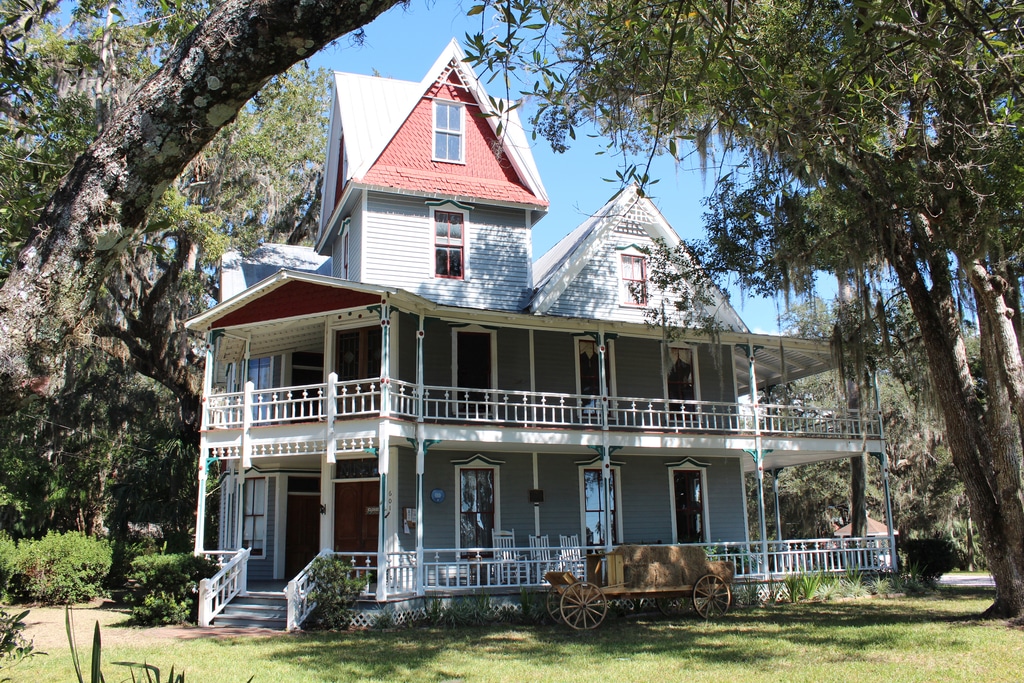 The image displays the May-Stringer House, a historic Queen Anne-style home located in Brooksville, Florida.