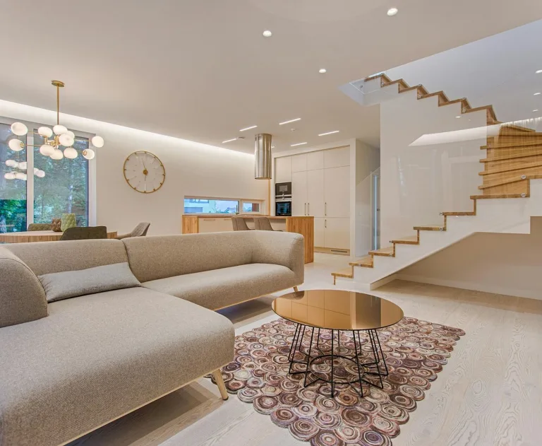 This image showcases a modern, open-plan living space featuring a minimalist design aesthetic and decorative interior lighting.