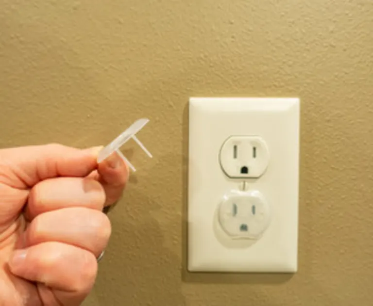 The item pictured is a plastic outlet plug cover used for childproofing electrical outlets.