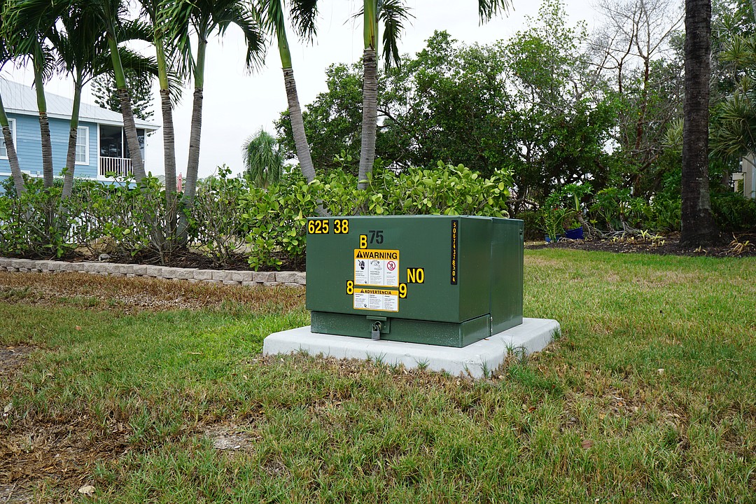 This item is a pad-mounted electrical transformer, commonly used in residential neighborhoods for underground utility systems.