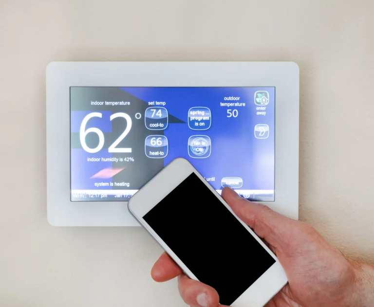 The image displays a smart thermostat interface being controlled via a smartphone.