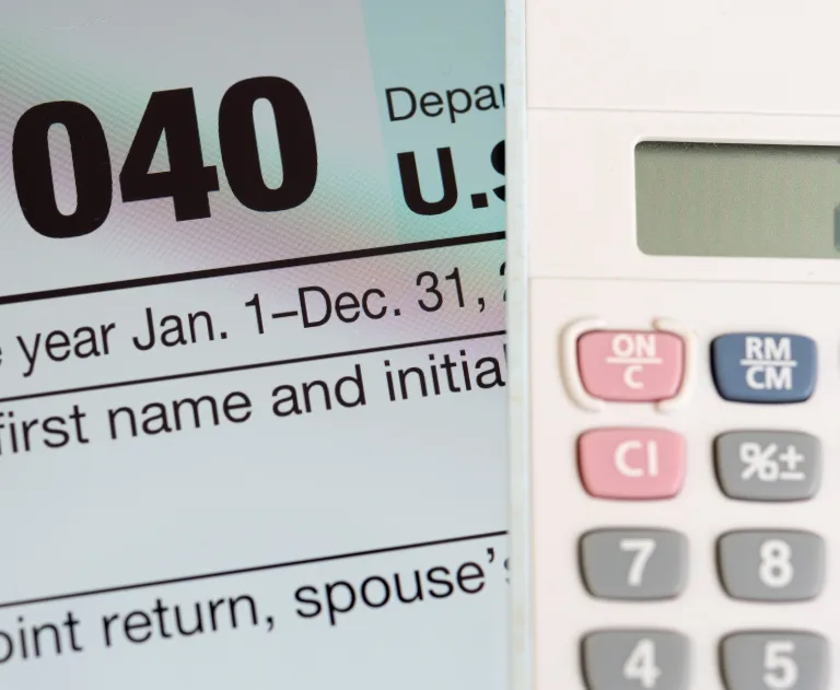 The image shows a portion of a U.S. tax form, specifically referencing "Form 1040" for the filing year, and a calculator.