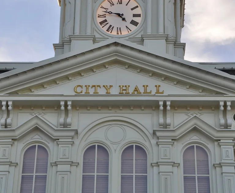 This image shows a city hall building with a clock tower.