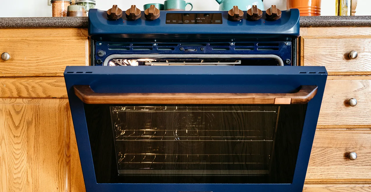 This is an induction range in blue with walnut accents. This 30-inch range is the first to feature a built-in battery, allowing it to plug into a standard 120V outlet without requiring a home electrical upgrade.The integrated 4.6kWh lithium iron phosphate battery supplies a burst of power for high-output cooking and can power other appliances during a power outage.