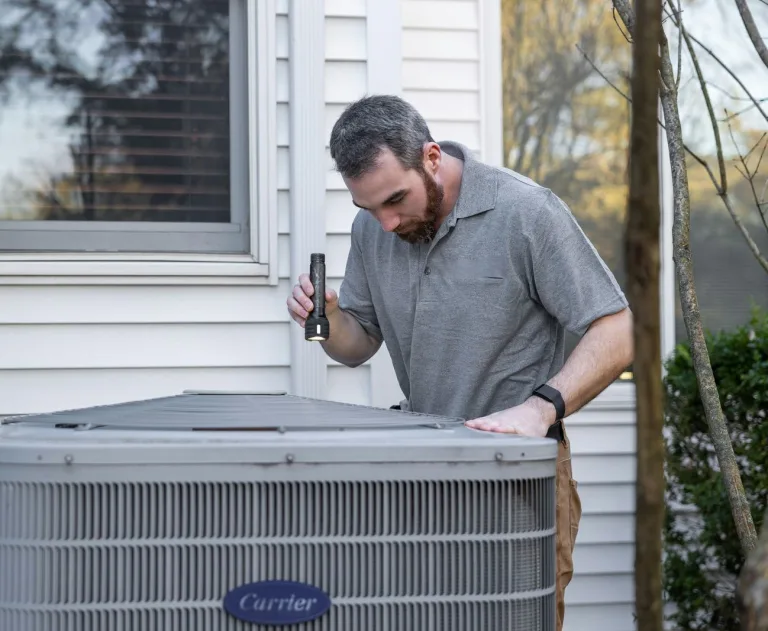 ee7a1744-3ed9-493a-8a58-ac379cf708cf_large - Thomas Edison Electric This image shows an electrician near me inspecting an air conditioning unit.