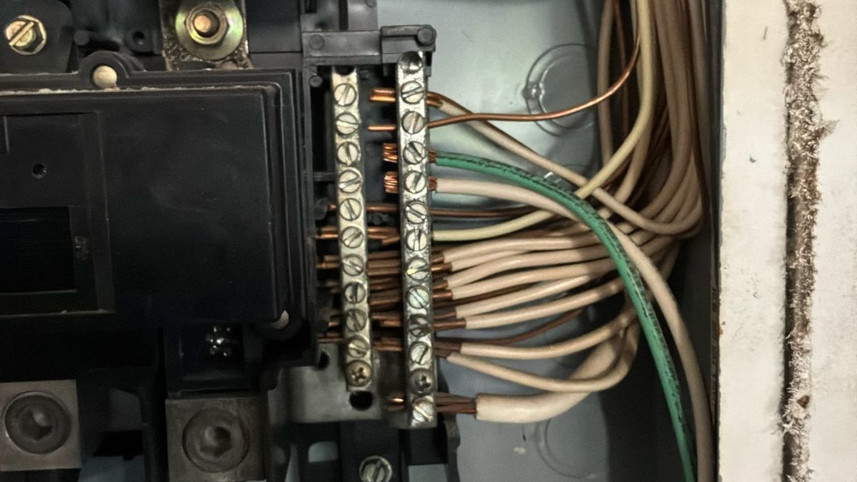 Branch circuit terminations on the neutral and ground bars inside an older residential electrical panel opened during an inspection in Lake Worth, Palm Beach County, Florida