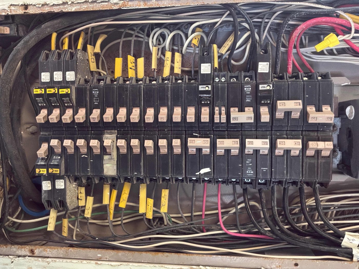 Older crowded residential electrical panel due for a service upgrade