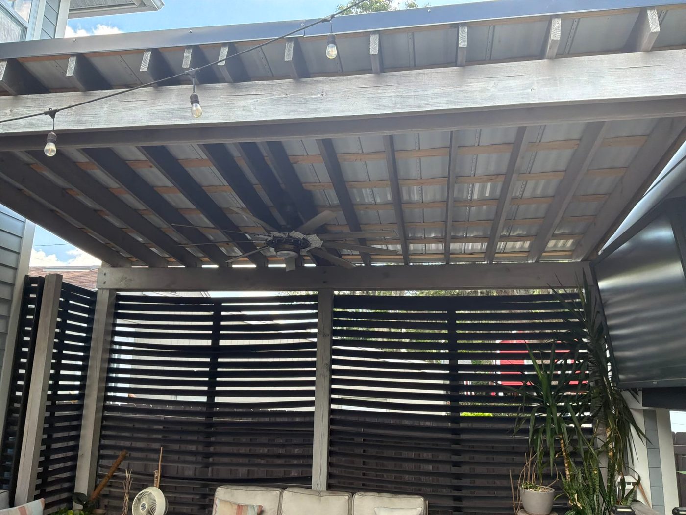 Outdoor patio string lighting and ceiling fan on a Florida lanai