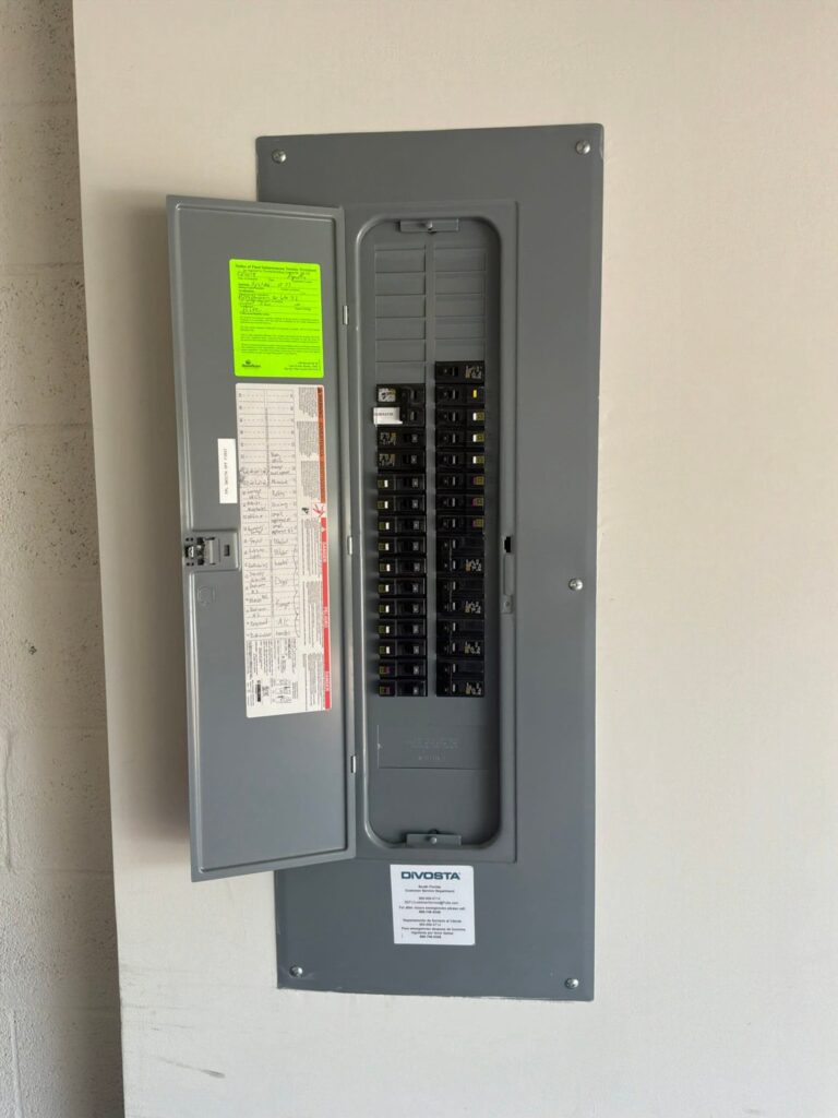 The electrical panel with its dead front in place documented before the work on an EV Charging Station Service/Repair job in Greenacres, FL.