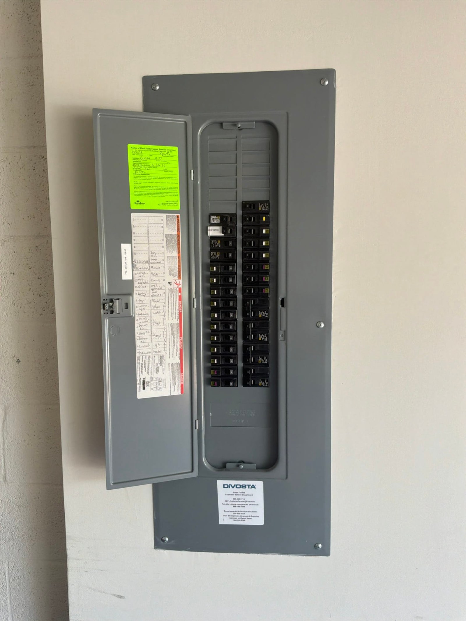The electrical panel with its dead front in place documented before the work on an EV Charging Station Service/Repair job in Greenacres, FL - Greenacres EV charger installation