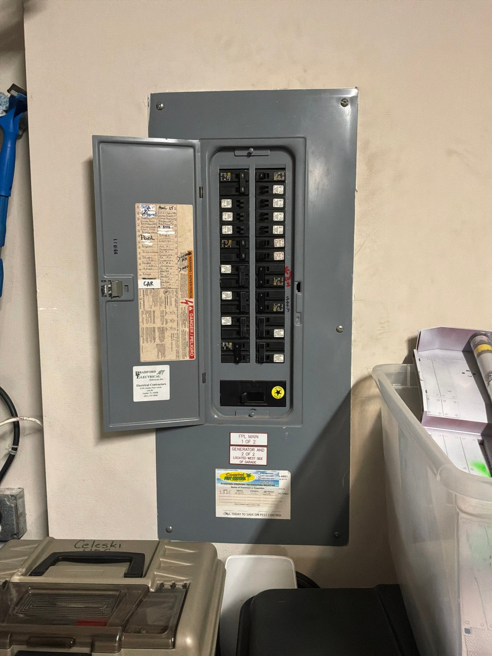 The electrical panel with its dead front in place documented before the work on an Outlet/GFCI-Repair/Replace job in Jupiter, FL.