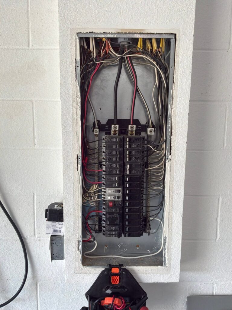 The inside of an electrical panel documented before the work on an Electric Fixture Service/Repair job in Winter Garden, FL.
